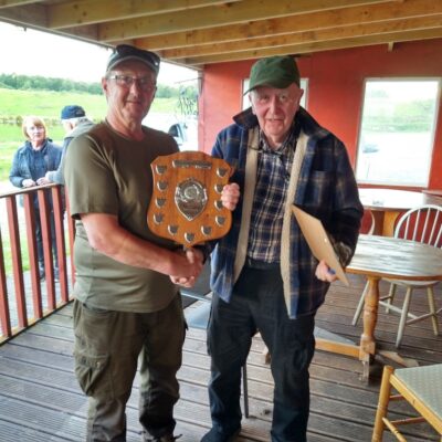 Iain Morrison receiving the Senior Shield from Neil Mackenzie